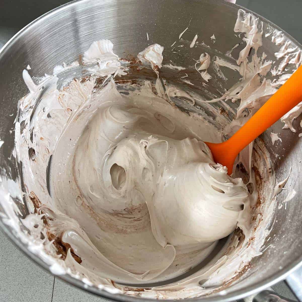 Chocolate pavlova mixture in a mixing bowl