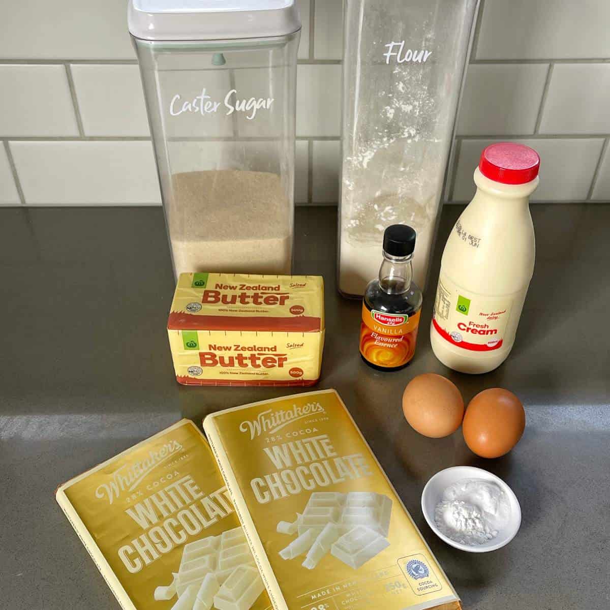 The ingredients for White Chocolate Mud Cake on a grey bench top