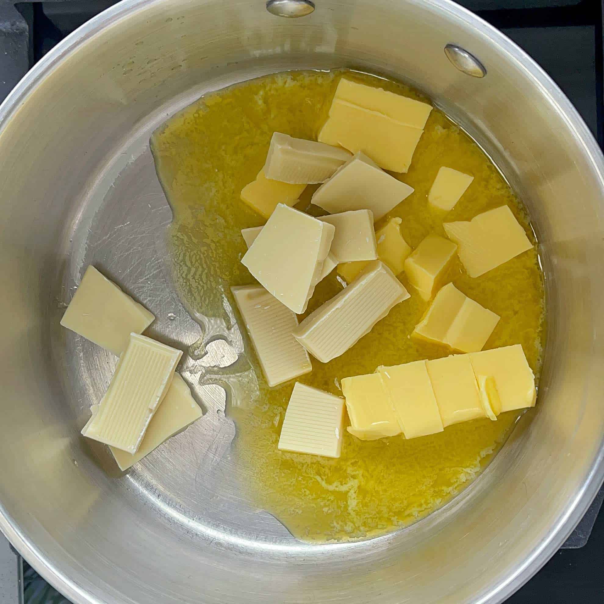 Butter and white chocolate melting together in a pot