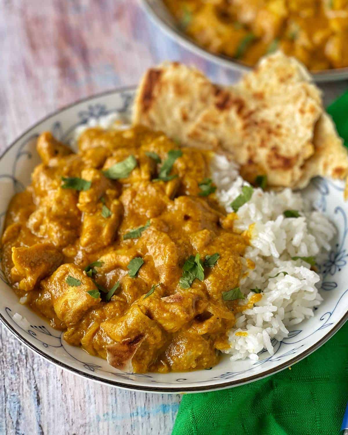 Chicken Korma served with fluffy white rice and naan bread