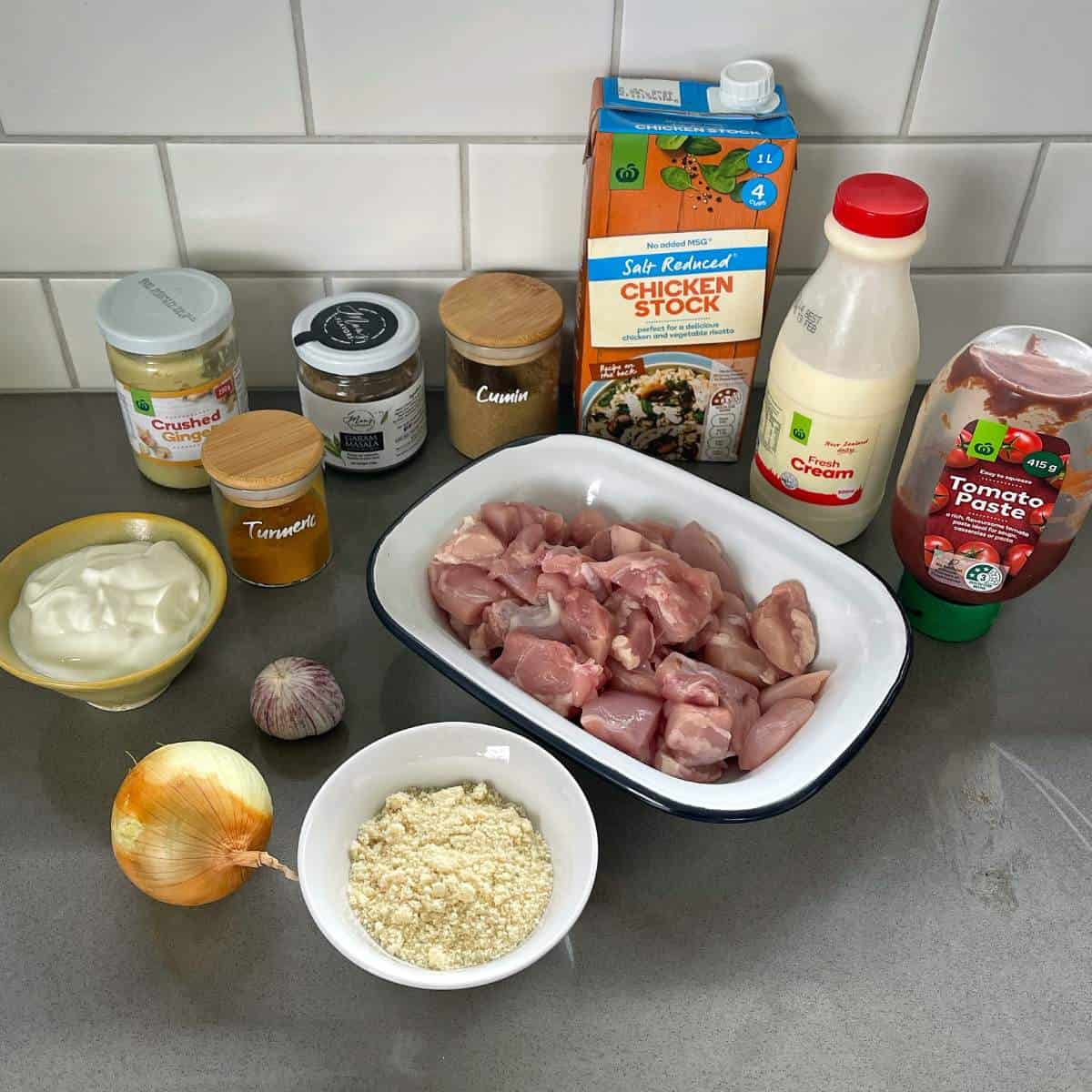 Ingredients for Chicken Korma on a grey bench top