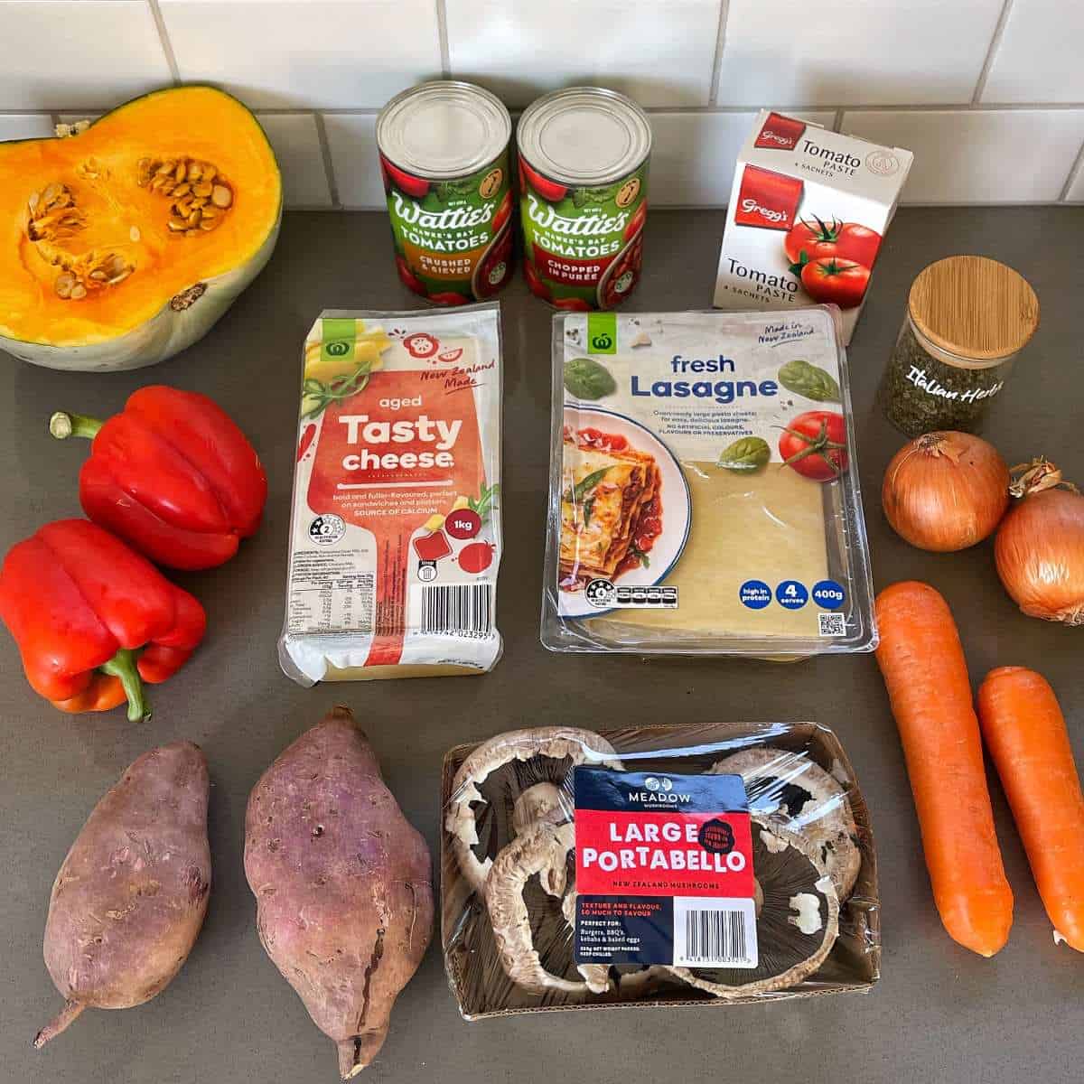 The ingredients for vegetarian lasagne on a grey bench top