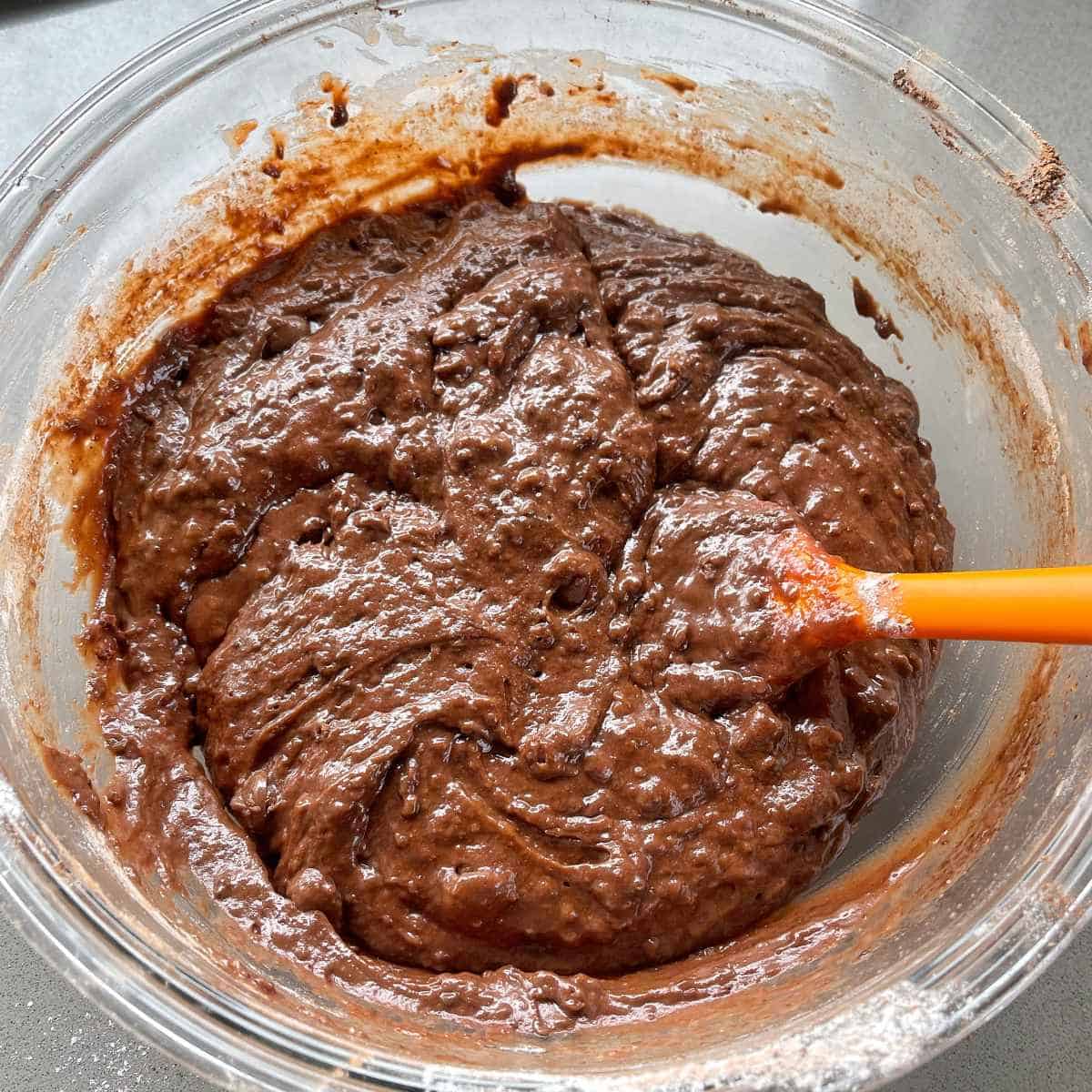 The mixed chocolate muffin mixture in a glass bowl