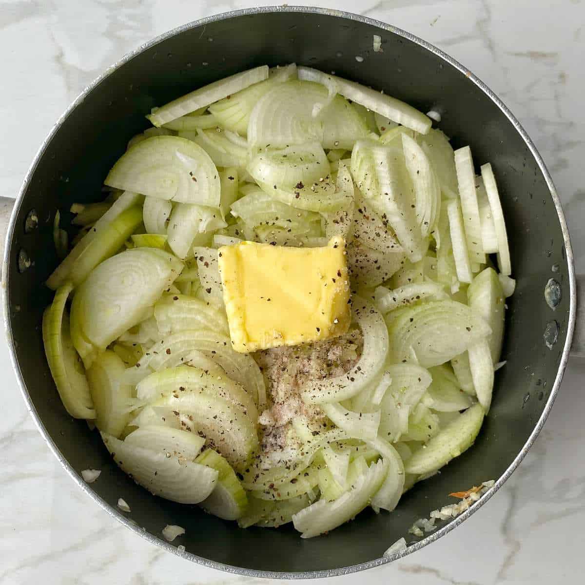 Sliced onions, butter, salt and pepper in a large pot