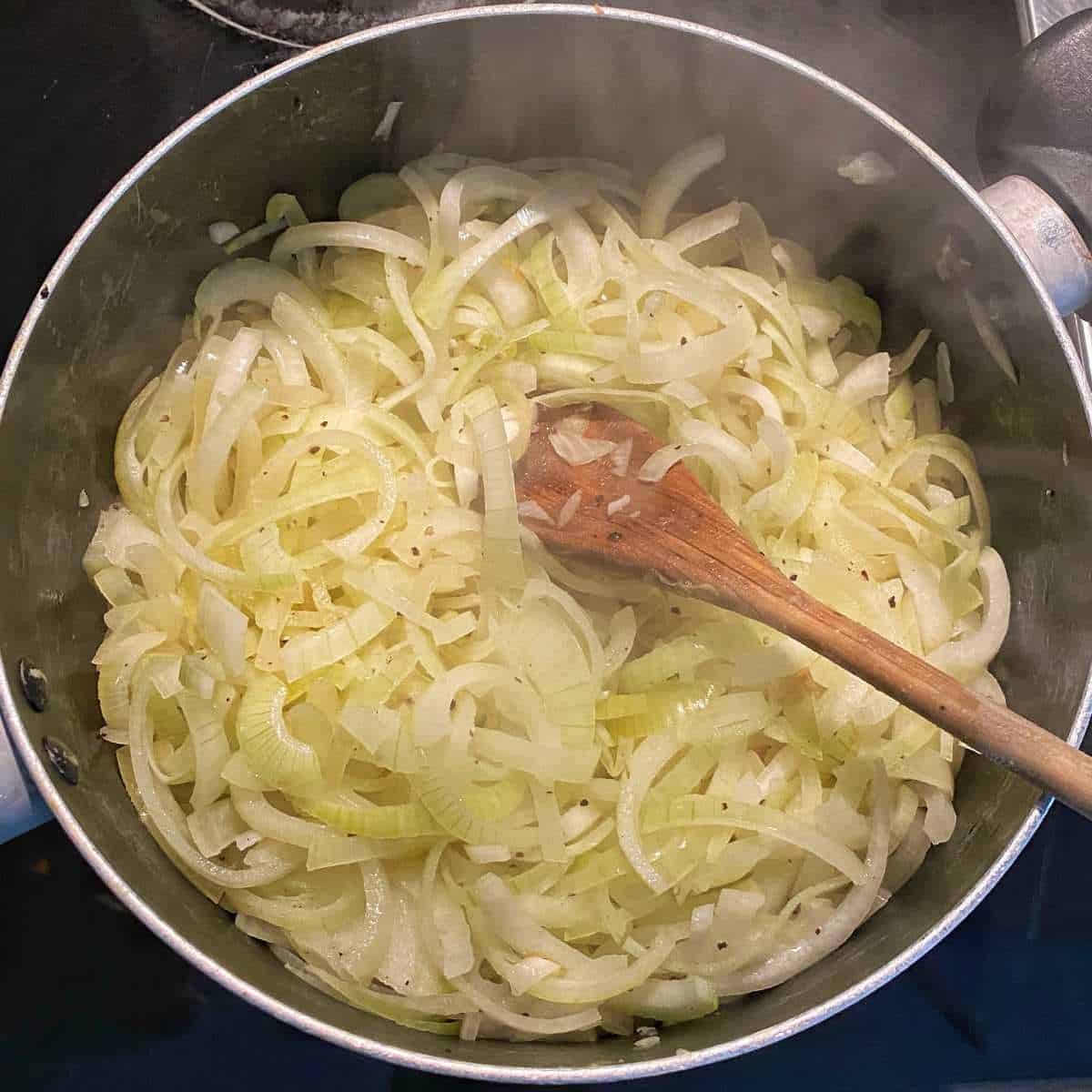 Simmering sliced onions, butter, salt and pepper in a large pot