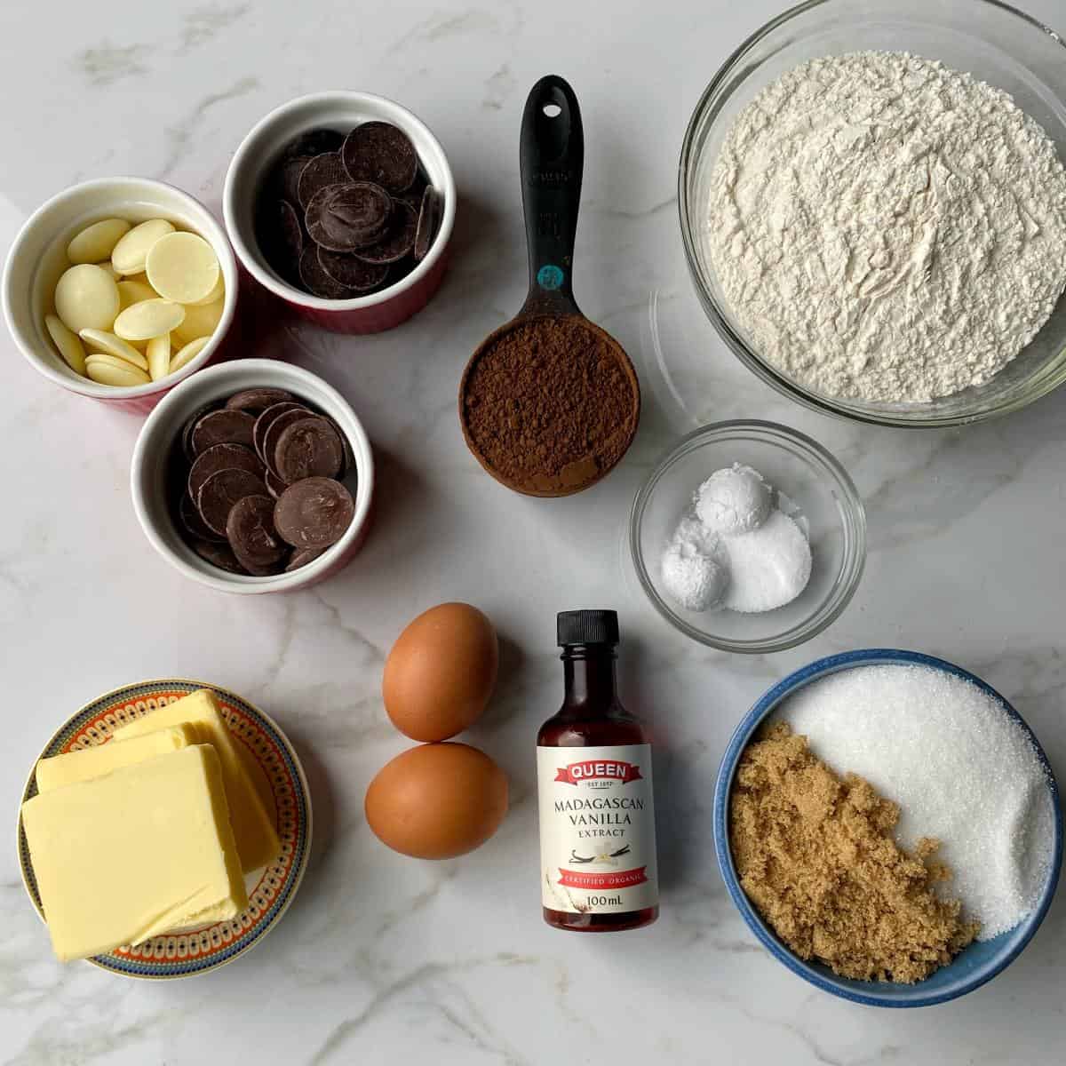 The ingredients for triple chocolate cookies on a marble bench top