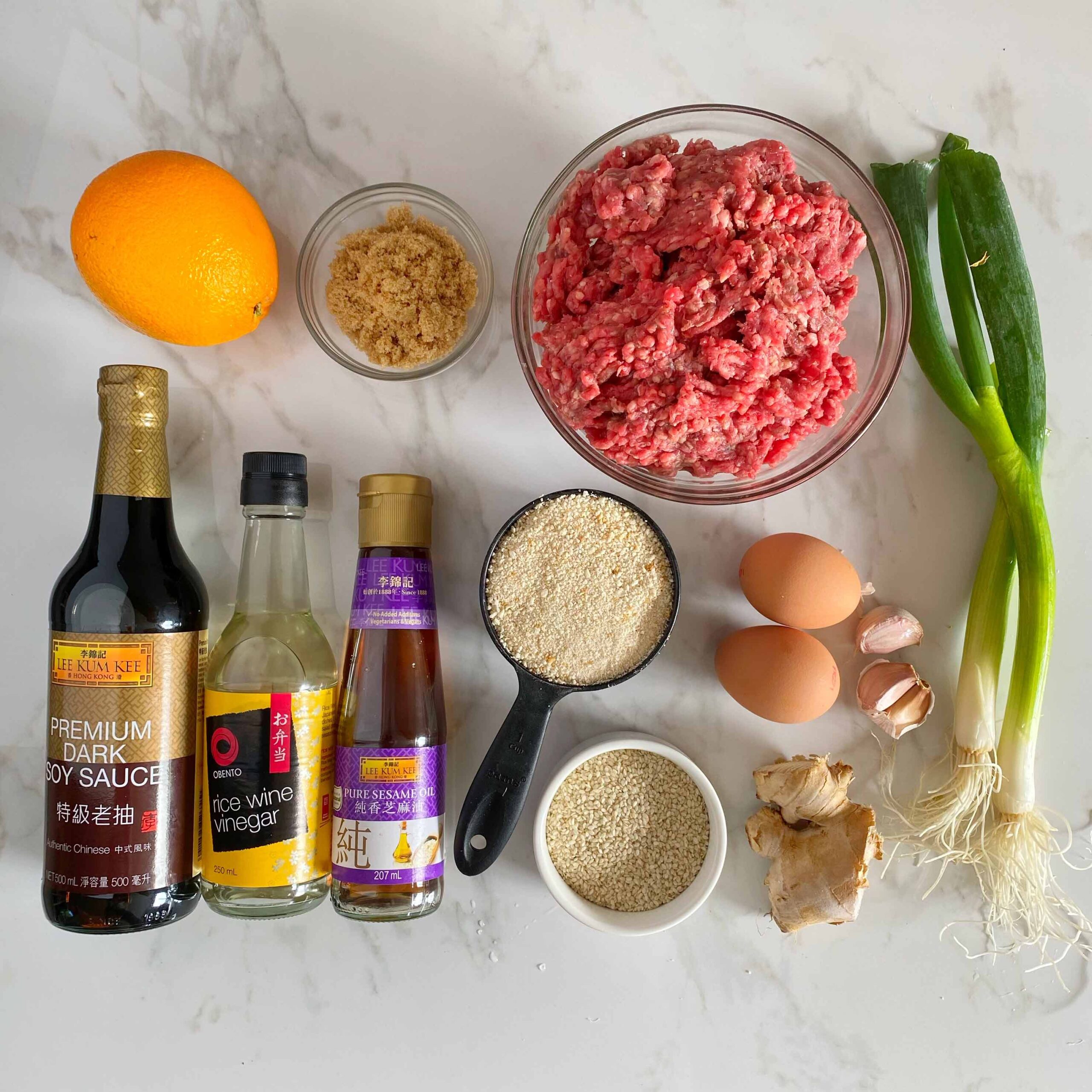 The ingredients for Sticky Asian Meatballs on a white bench.