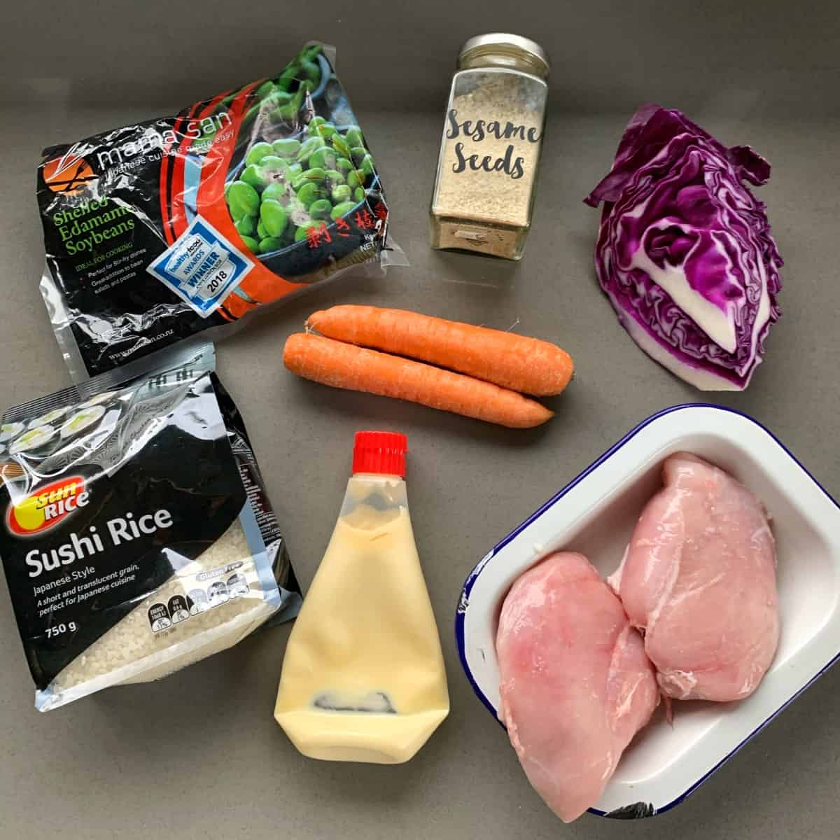 The ingredients for Quick Teriyaki Sushi bowls on a grey bench.