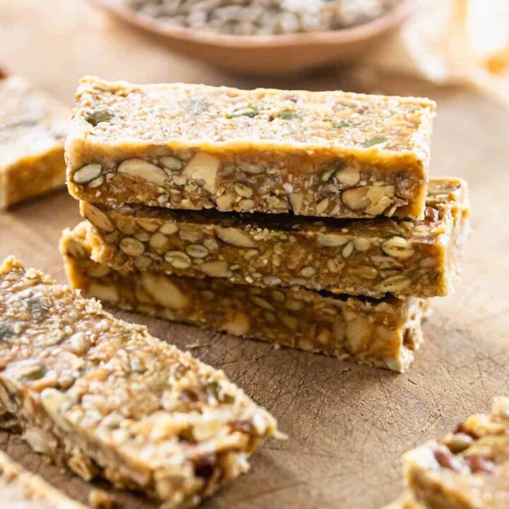 A stack of Nuts and Seeds Muesli Bars on a wooden chopping board