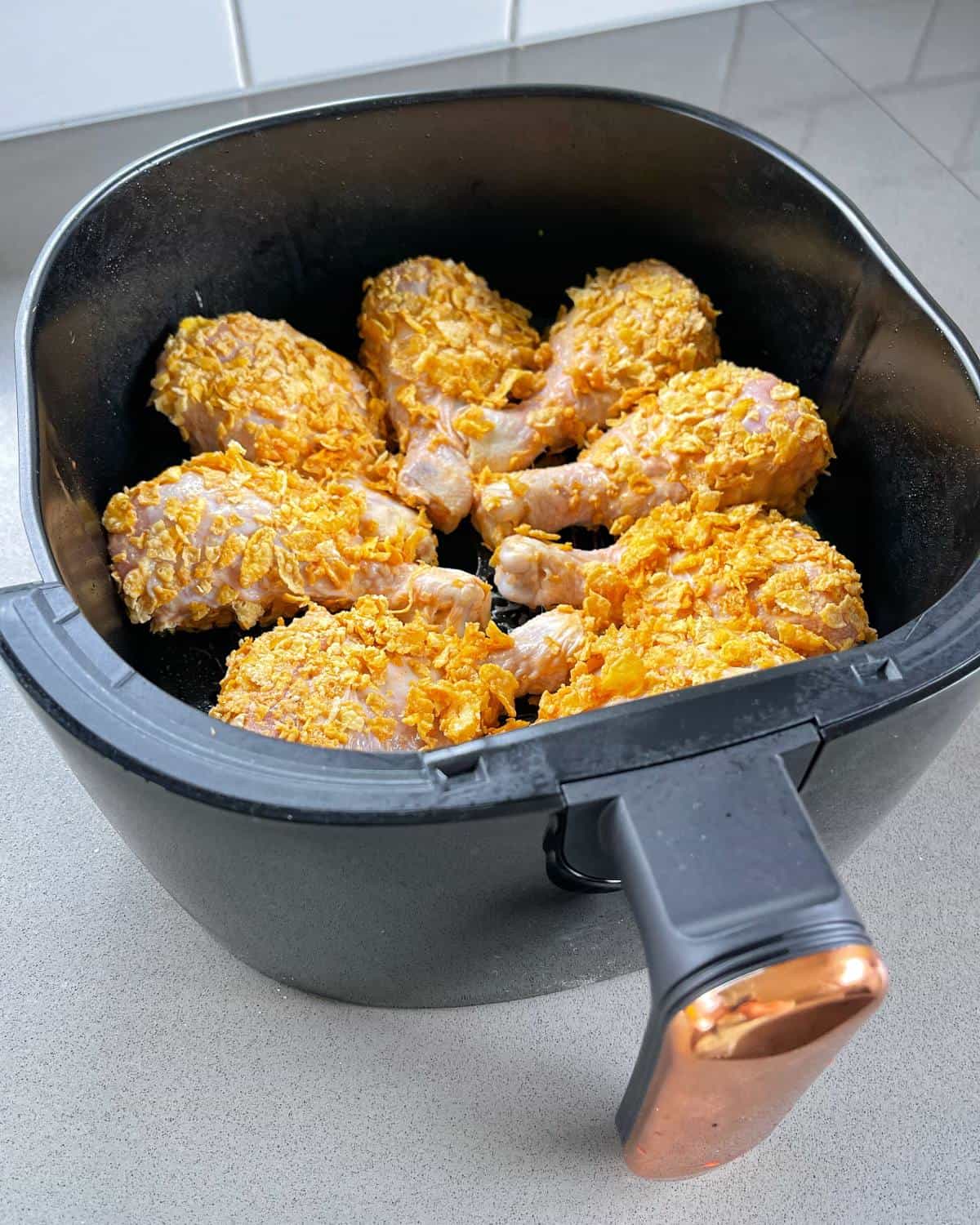 Crispy chicken Drumsticks in the base of the air fryer.