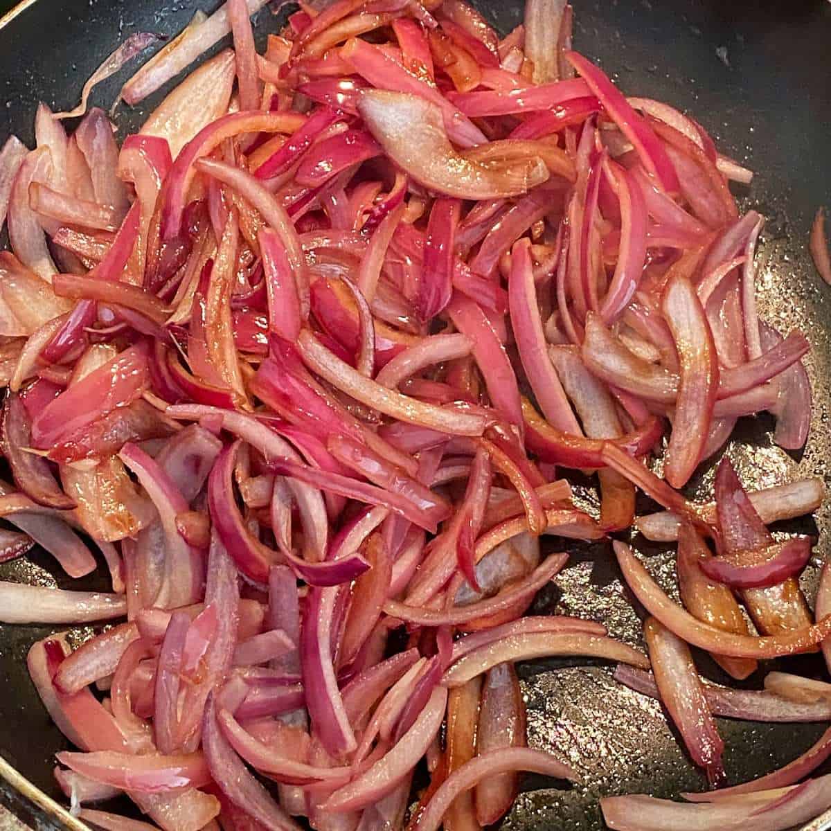 Red onion caramelizing in a fry pan