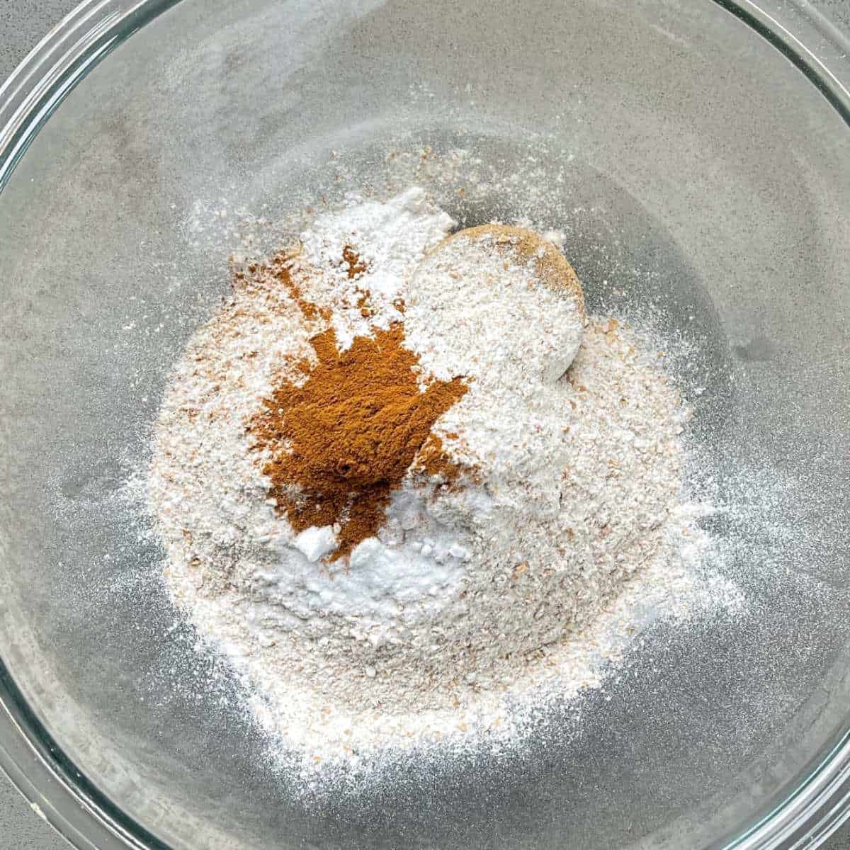 The dry ingredients for ABC Muffins in a glass bowl