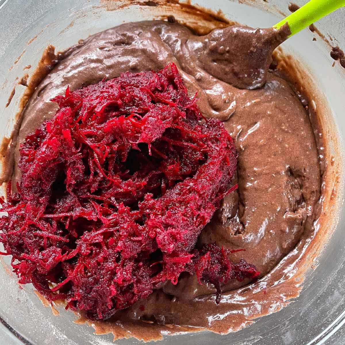 The Beetroot and Chocolate loaf mixture in a glass bowl, the grated beetroot has been added but not stirred through.