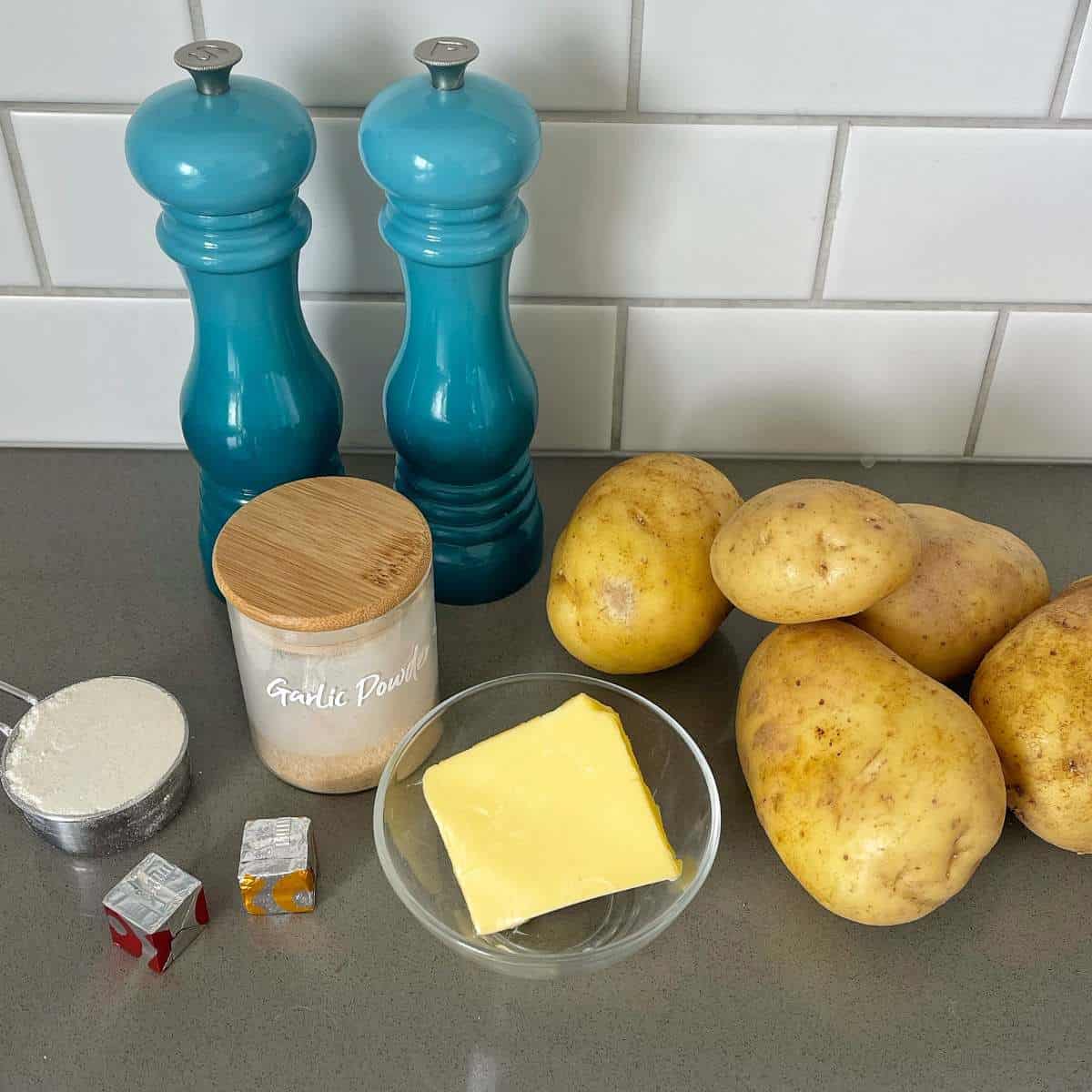 The ingredients for Potato and Gravy on a grey bench top.