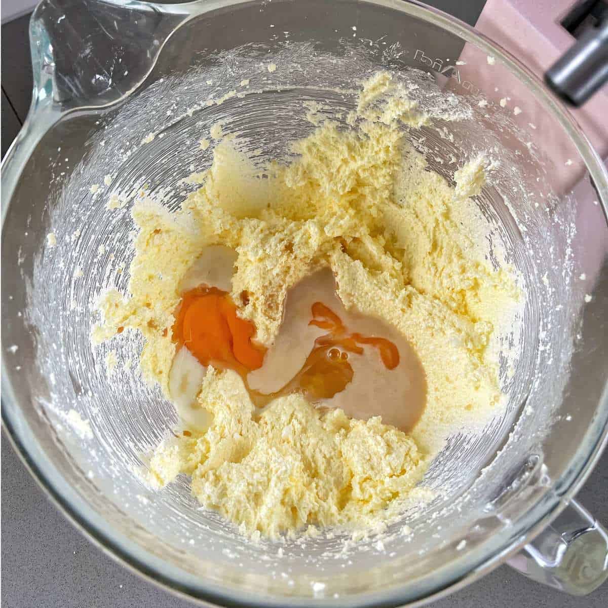 Butter, sugar and an egg in the base of a stand mixer.