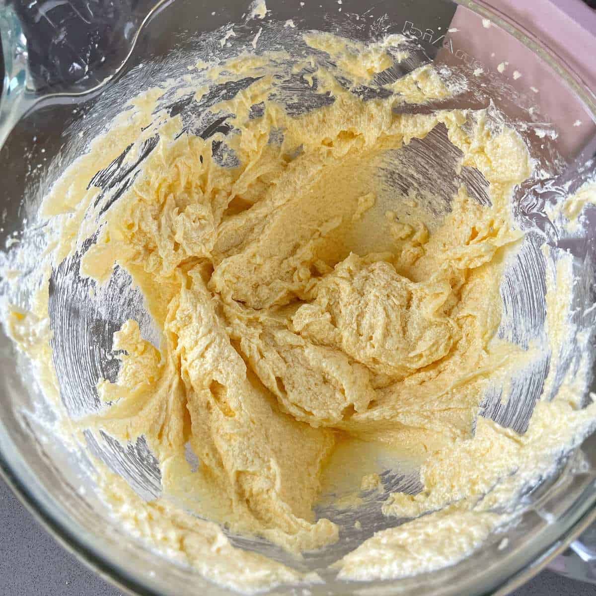 The mixture for snickerdoodles in the base of a stand mixer.