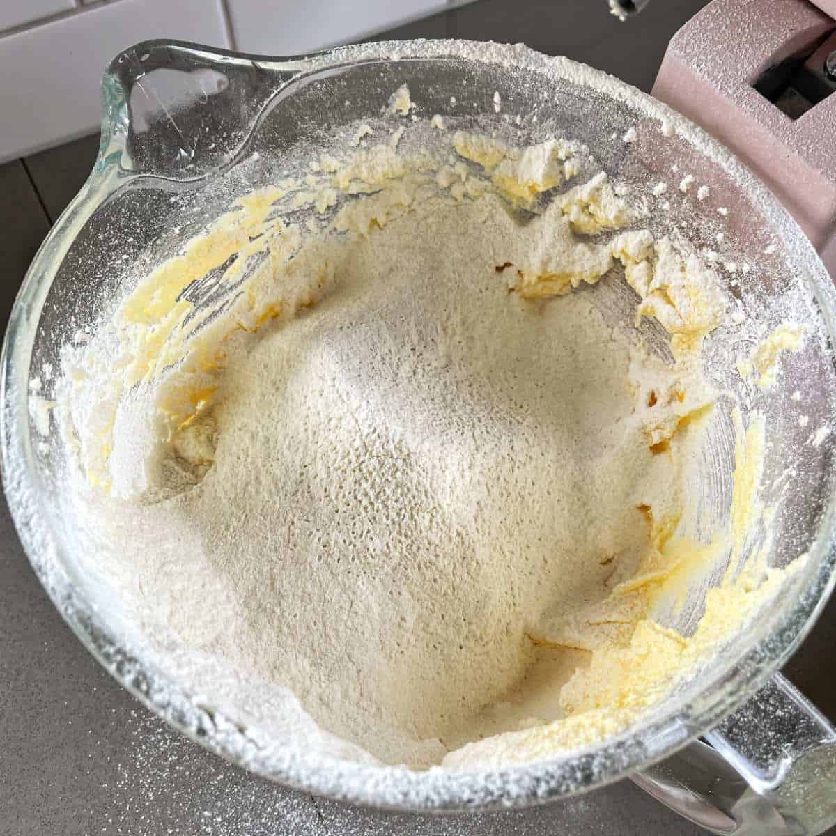 Flour added to cookie mixture in a stand mixer.
