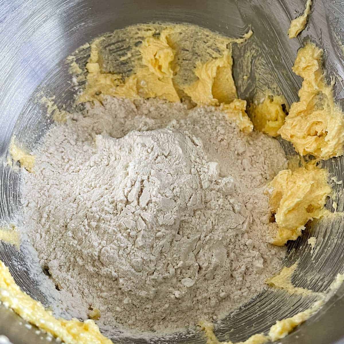 Flour being added to the creamed butter, egg and sugar for the Baked Apricot Slice