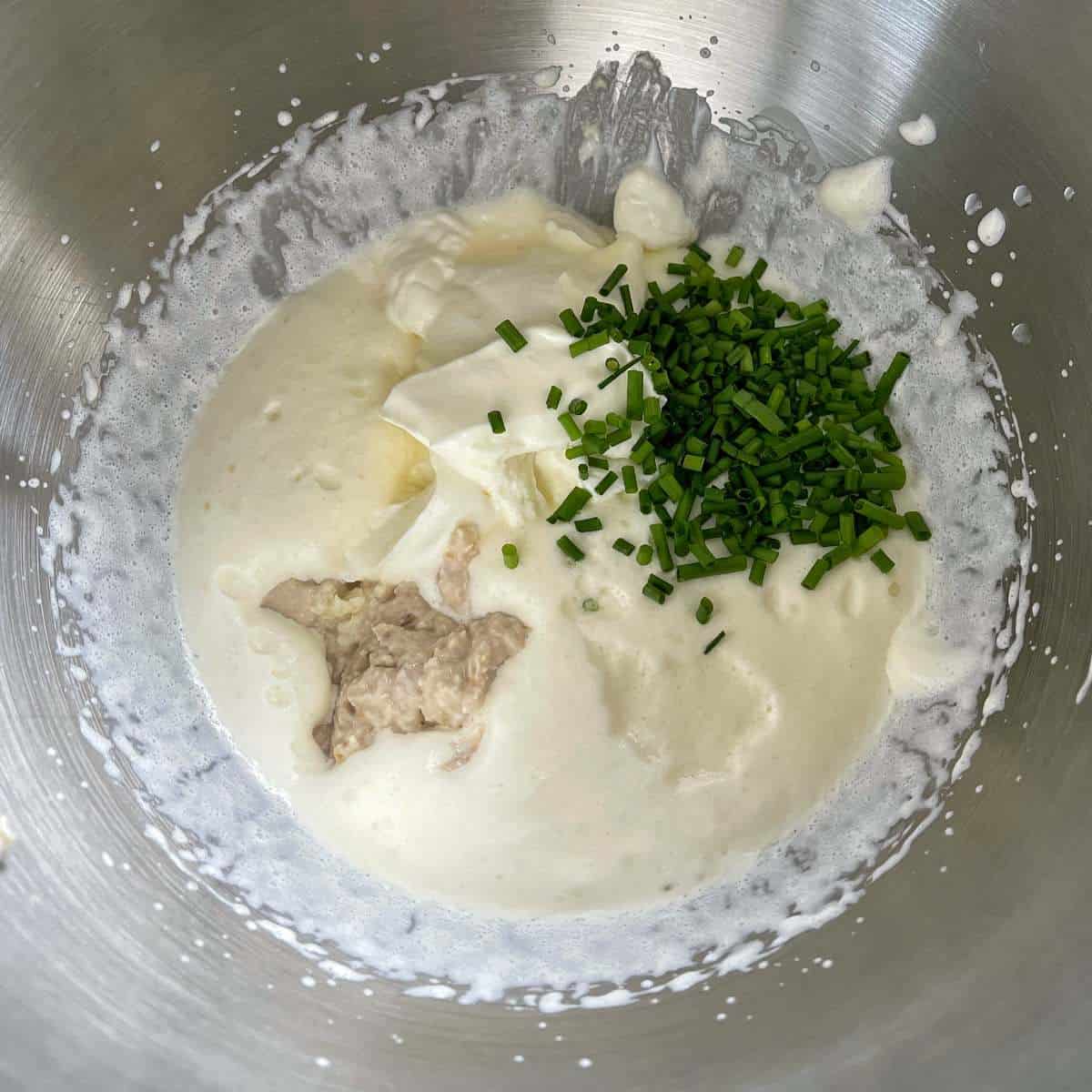 The ingredents to make creamed horseradish in a mixing bowl before it has been mixed and combined together.