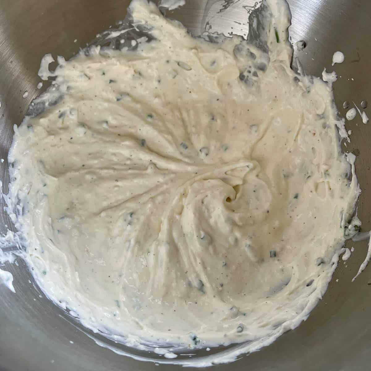The creamed horseradish in a mixing bowl