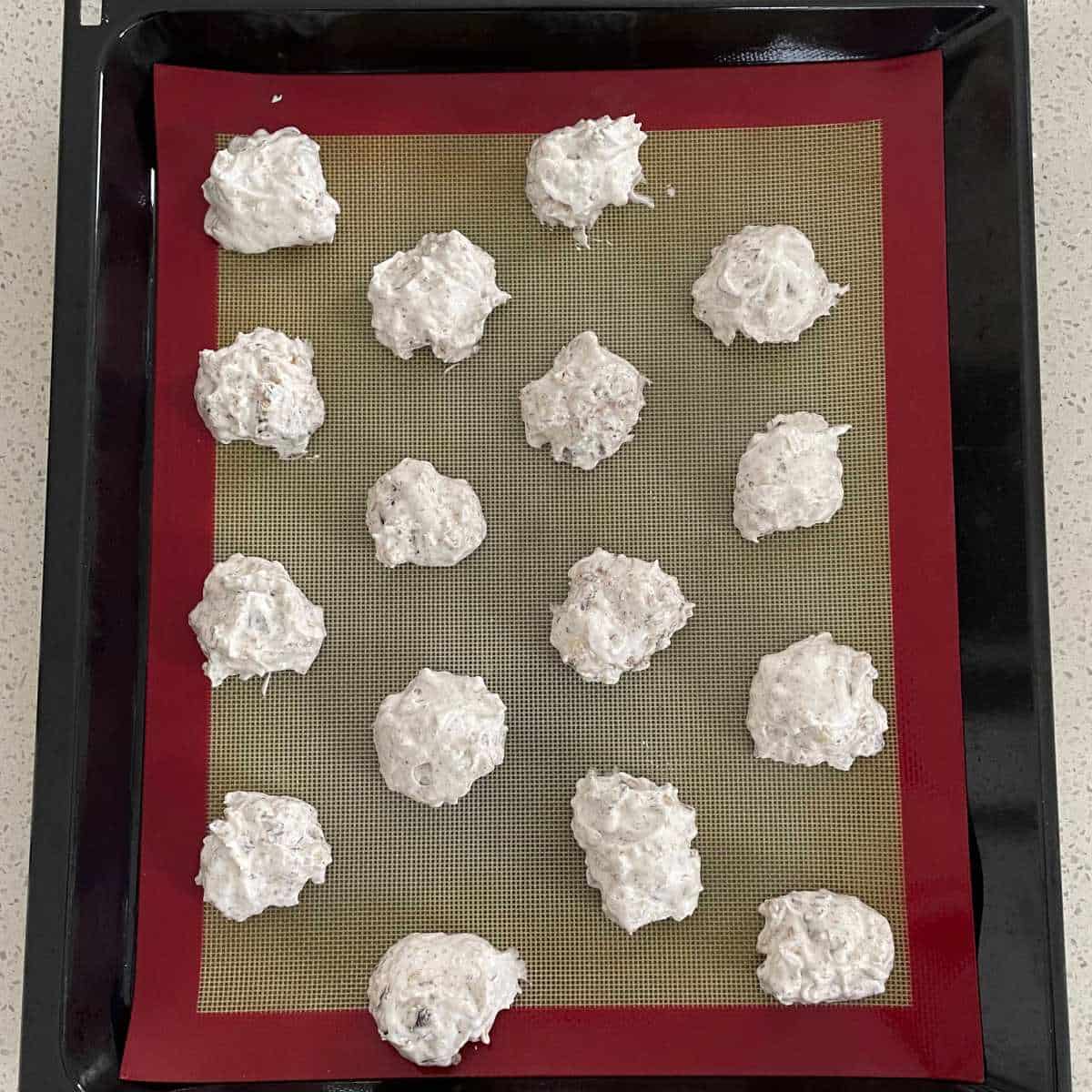 Uncooked Chocolate Almond Meringue Cookies on a baking tray