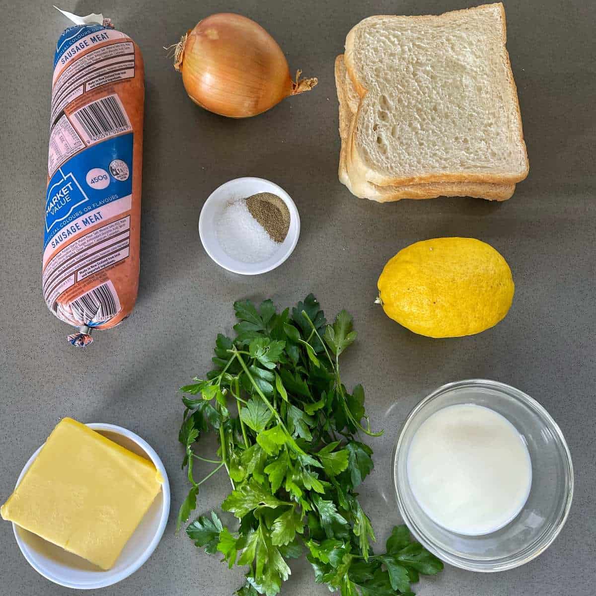 The ingredients for classic stuffing on a grey bench top.