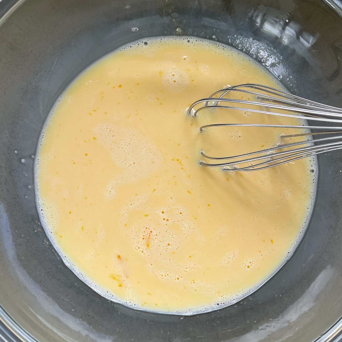 Eggs whisked together in a bowl.