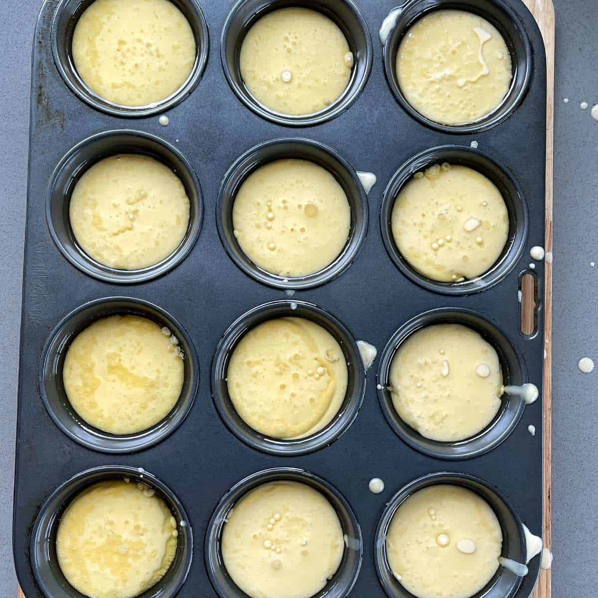 Uncooked Yorkshire pudding batter in a muffin tin