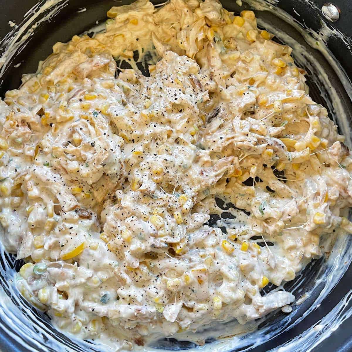 A creamy chicken mix sitting in a frying pan. 