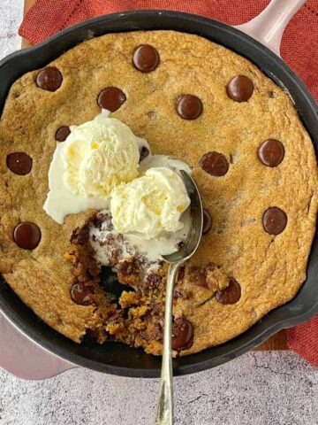 Cooked Chocolate Chip Skillet Cookie served with vanilla ice-cream.