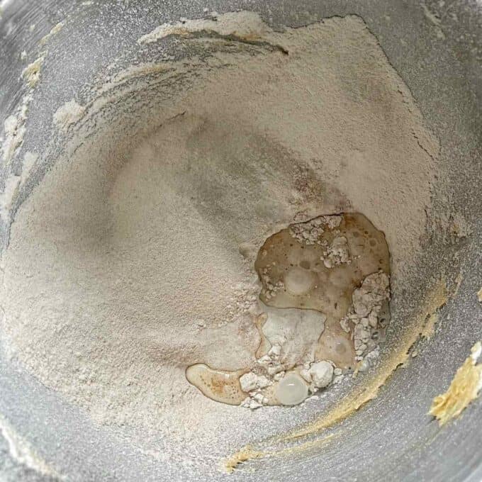 The dry ingredients and milk which have been added to the creamed butter and sugar mixture for the cookie dough.