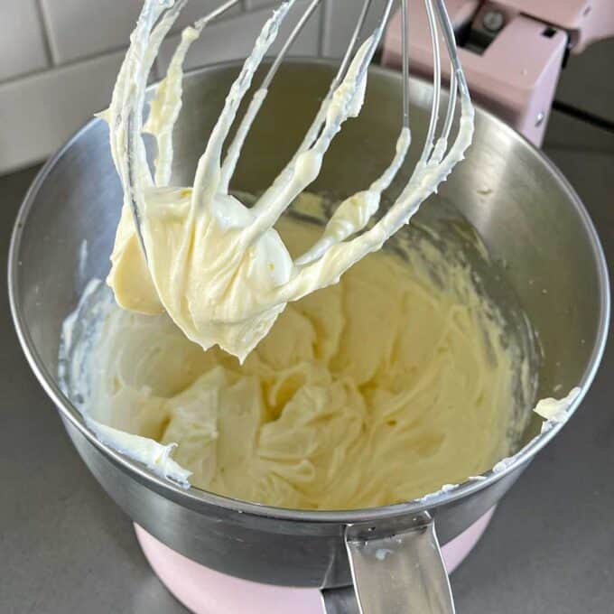 The lemon curd cheesecake filling in a mixing bowl.