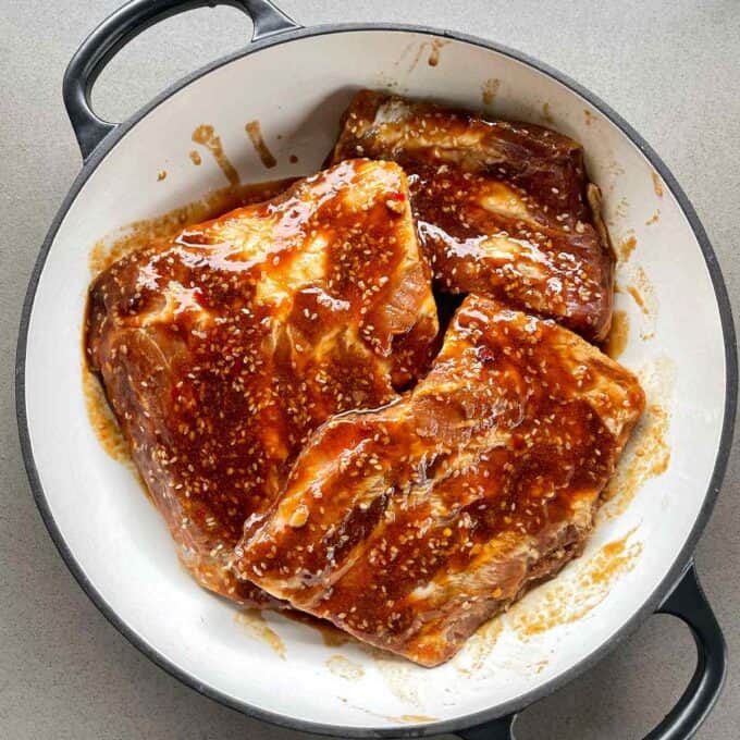 Marinated ribs in an oven proof dish prior to being cooked.