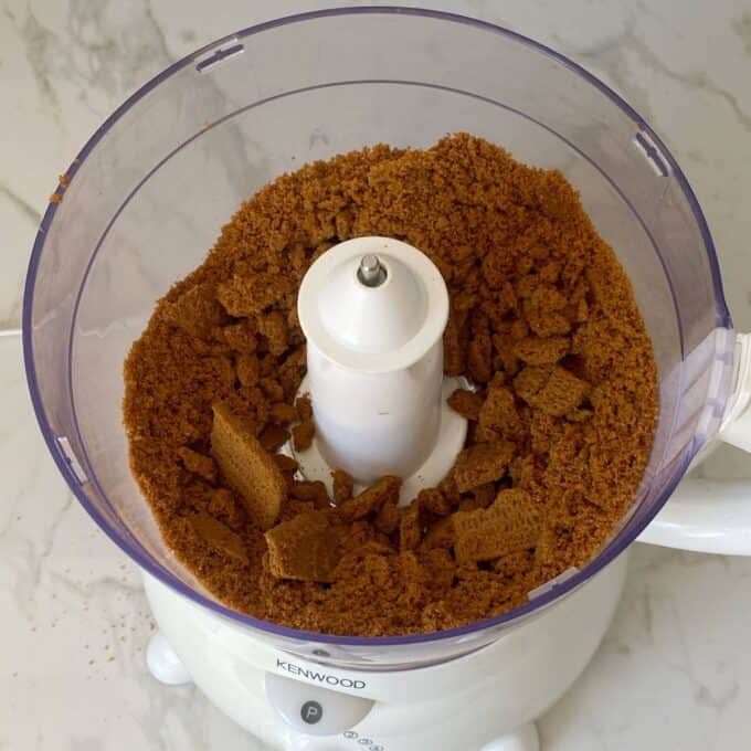 Biscoff biscuits in a food processor being turned into crumbs for the base of the cheesecake.