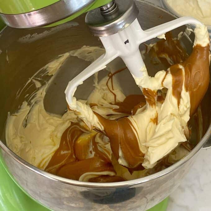 A cake mixer mixing the biscoff filling with the cream cheese mixture.