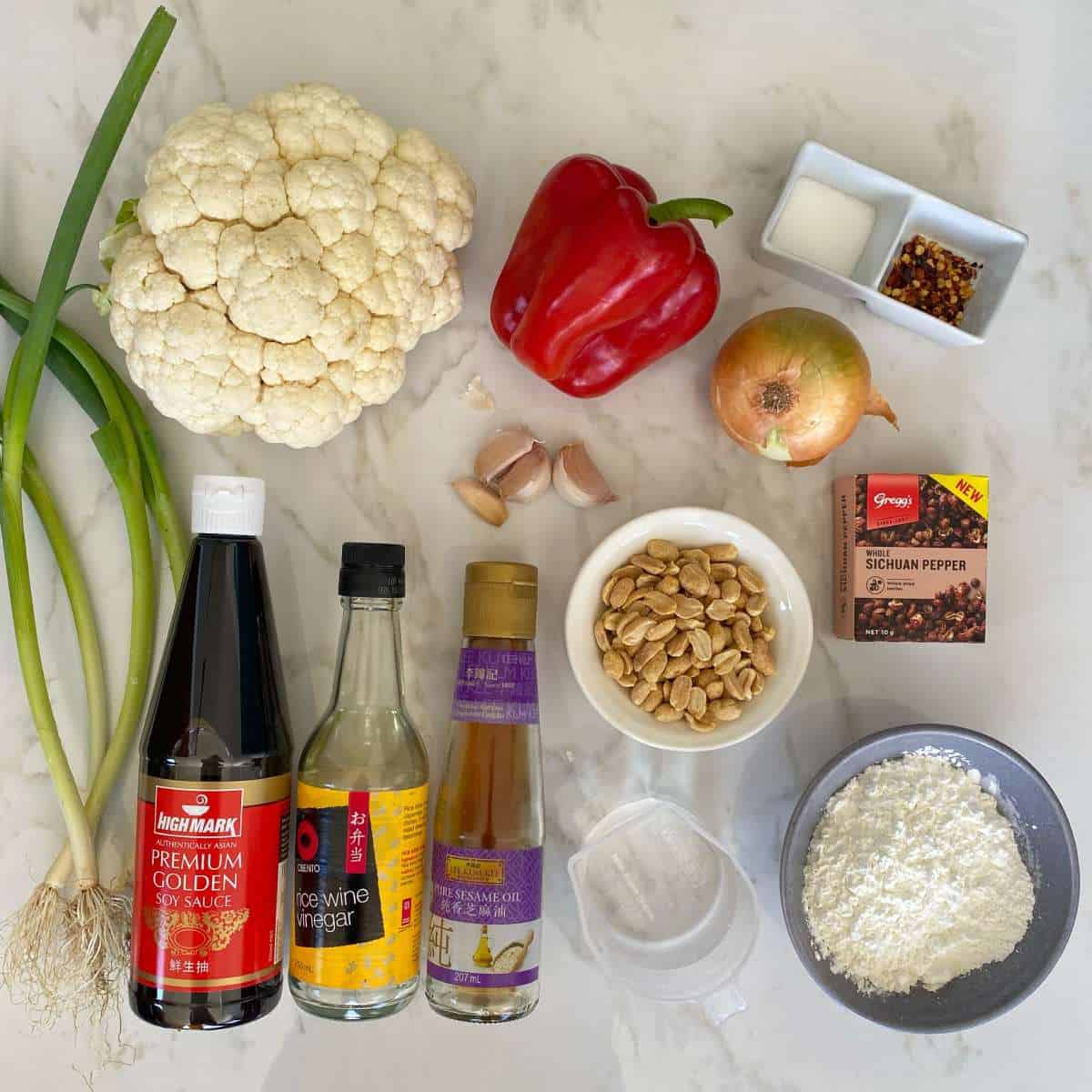 The ingredients for Kung Pao Cauliflower on a marble bench top.