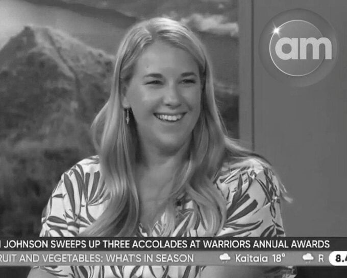 A black and white photo of a woman smiling on the AM show.