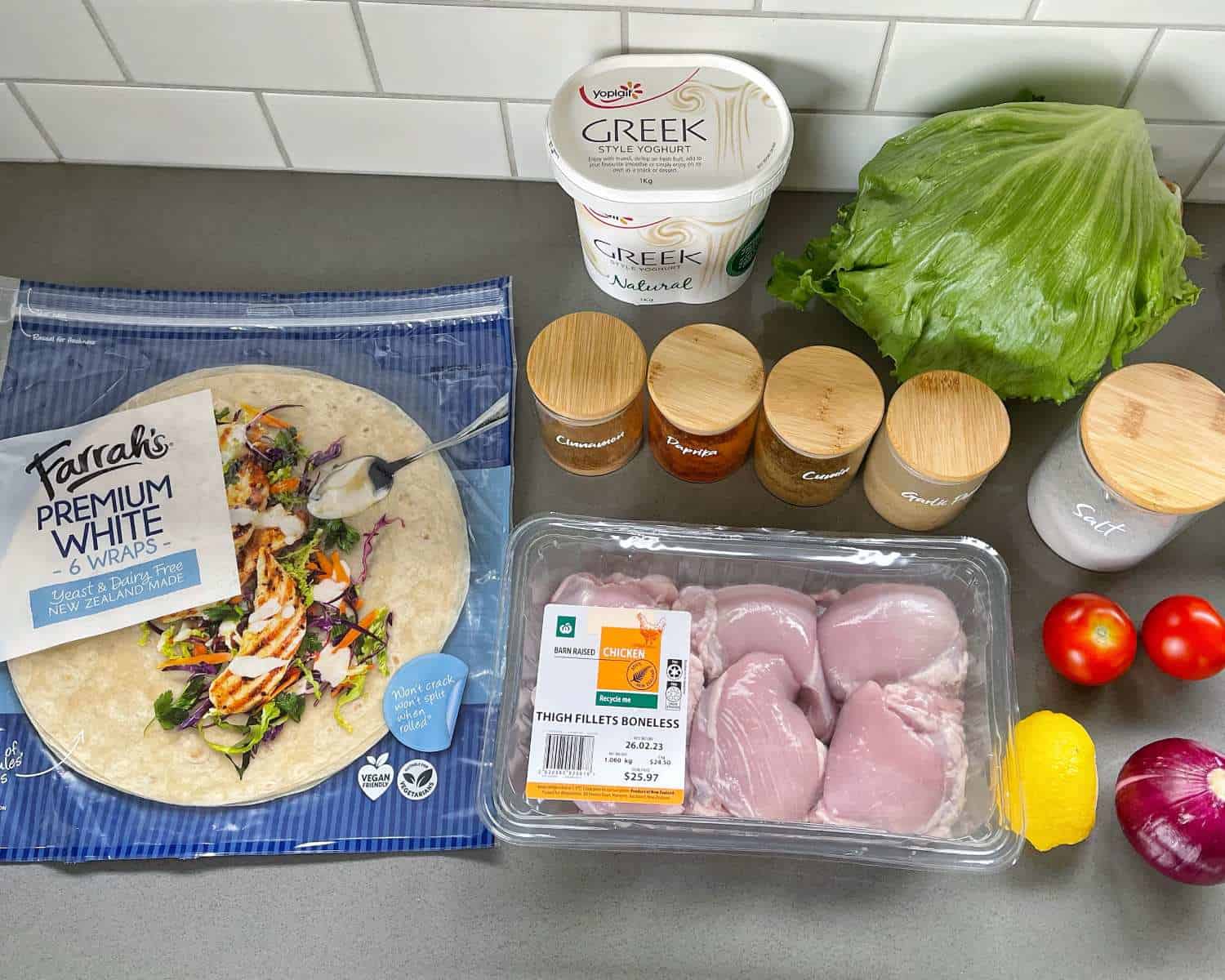 Ingredients for making Chicken Gyros on a grey benchtop. 