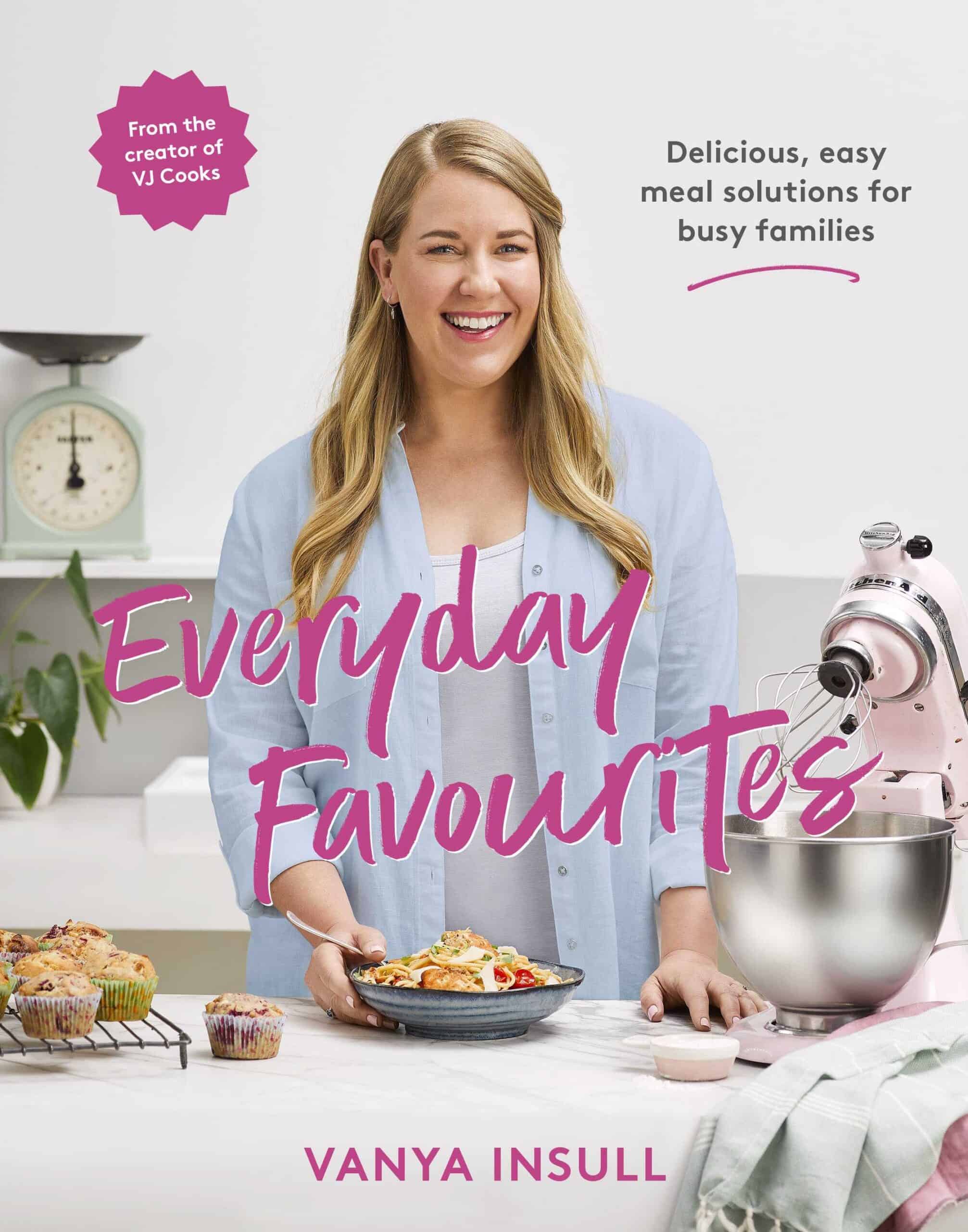A woman stands in a kitchen smiling and holding a plate of food, surrounded by baking ingredients, a mixer, and pies; the text reads Everyday Favourites by Vanya Insull, sharing her favourite recipes for everyday enjoyment.