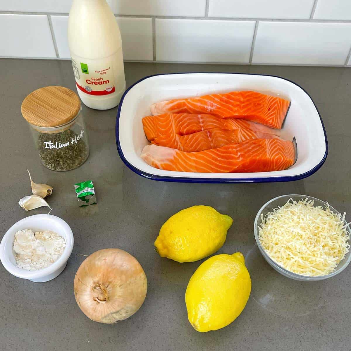 The ingredients for Creamy Salmon fillets on a grey bench top