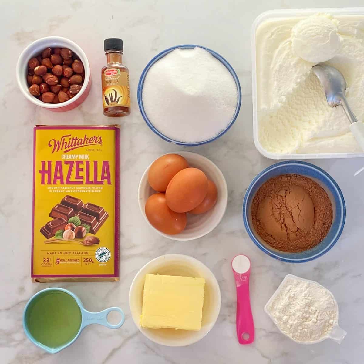 The ingredients for Hazella Brownie Sundae on a marbel bench top.