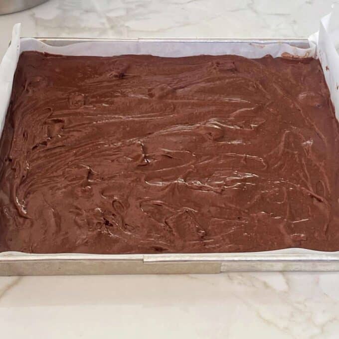 Raw chocolate brownie in a baking dish.