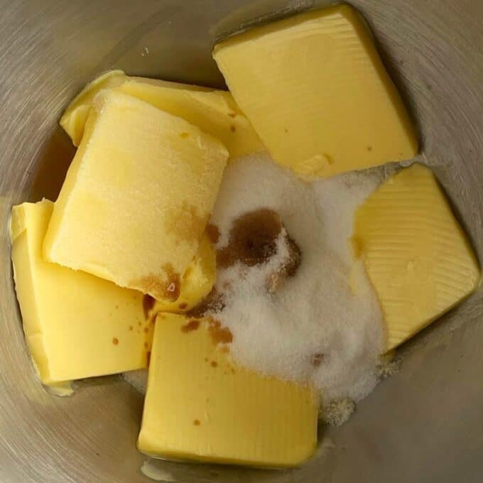 Butter, sugar and vanilla essence in a mixing bowl.