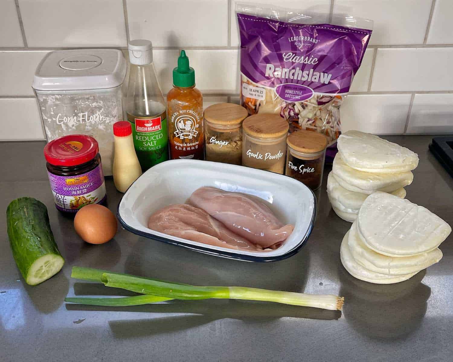 The ingredients to make Crispy Chicken Bao Buns on a grey bench top.