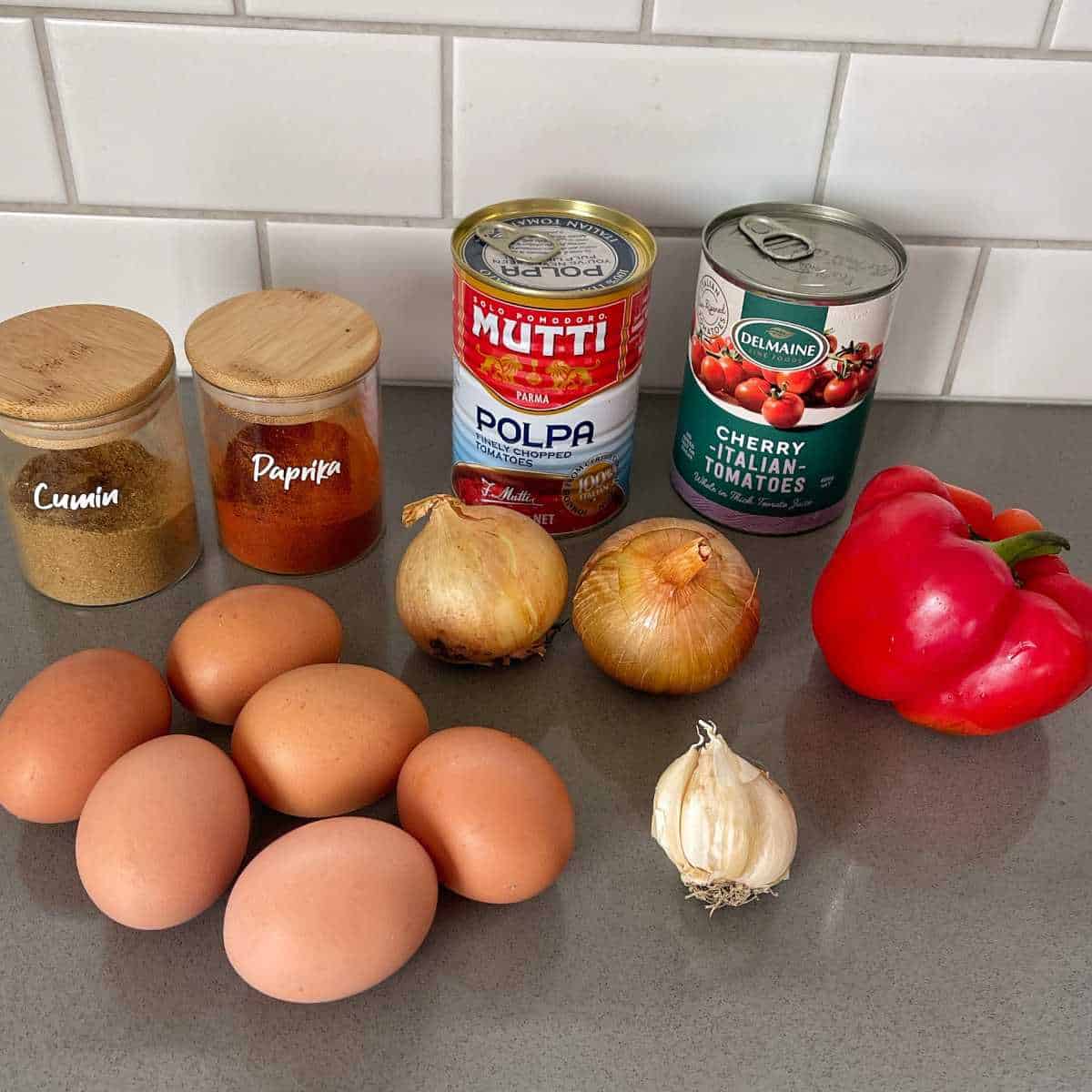 The ingredients to make Egg Shahouka on a grey bench top