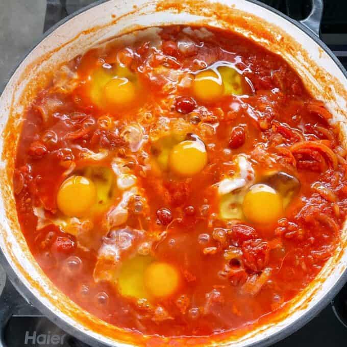 SIx eggs that have been added to the Egg Shahouka mixture to slowly cook through.