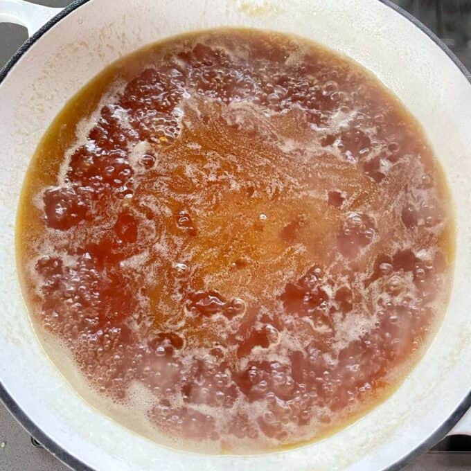 Melted butter and golden syrup simmering in a round ceramic dish over the hob.