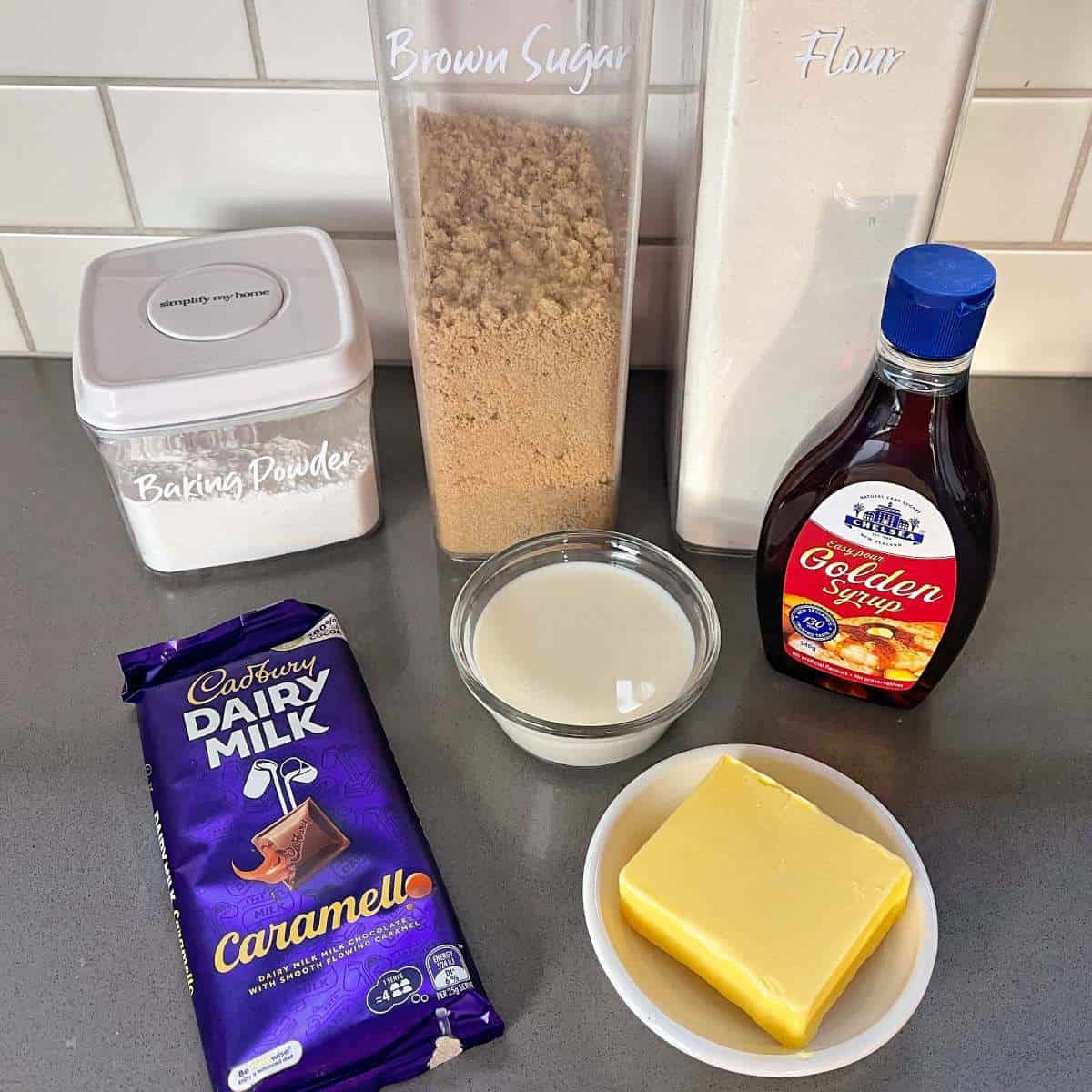 The ingredinets for golden syrup dumplings on a grey bench top.