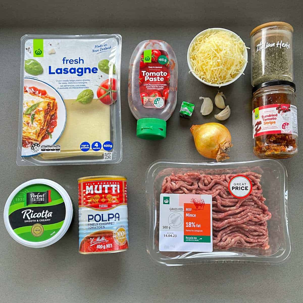 The ingredients for one pot lasagne on a grey bench top.