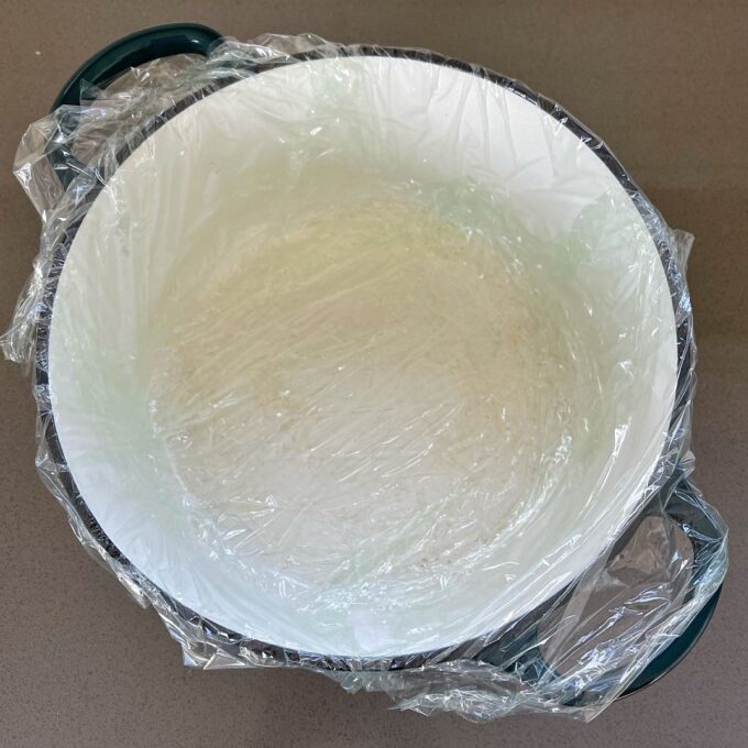 A large cast iron dish lined with cling film.